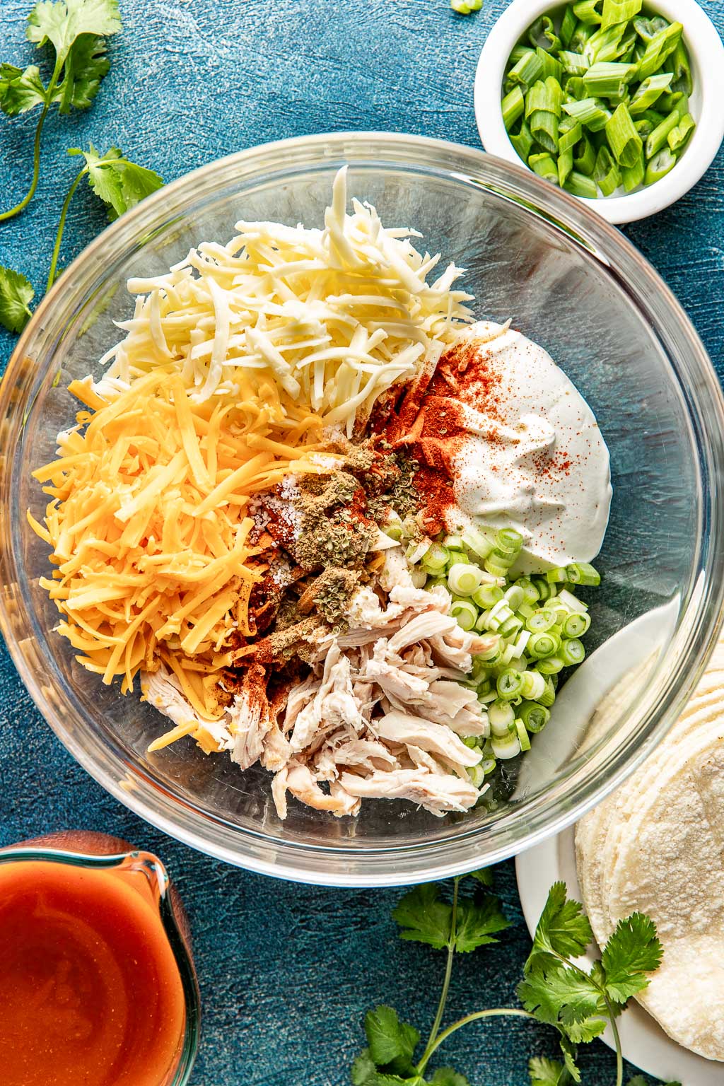 Ingredients for chicken enchilada filling in a mixing bowl 