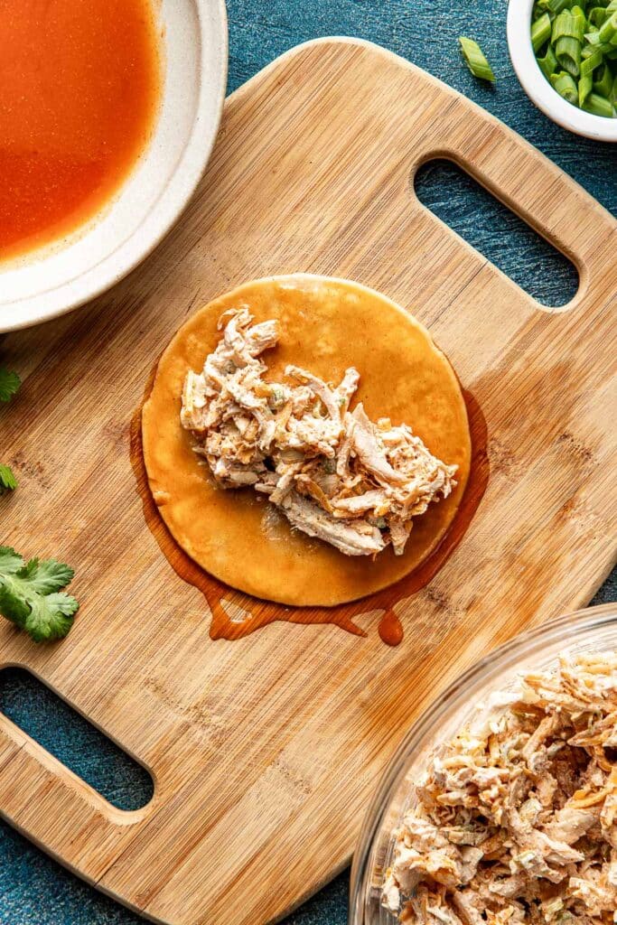 chicken enchilada filling in the center of a corn tortilla