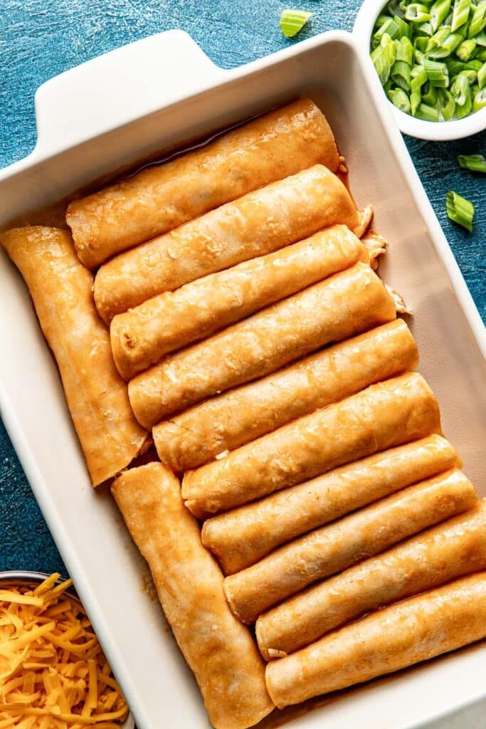 rolled enchiladas in a baking dish
