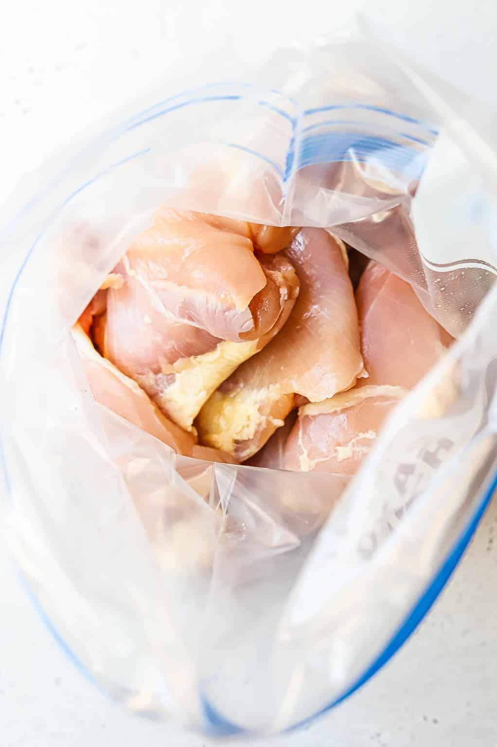 raw chicken breasts in a bag 