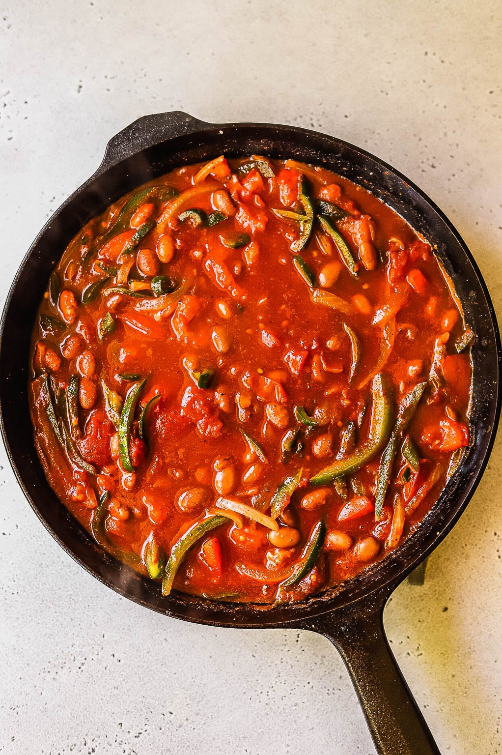Tomatoes, beans, and veggies in a skillet 