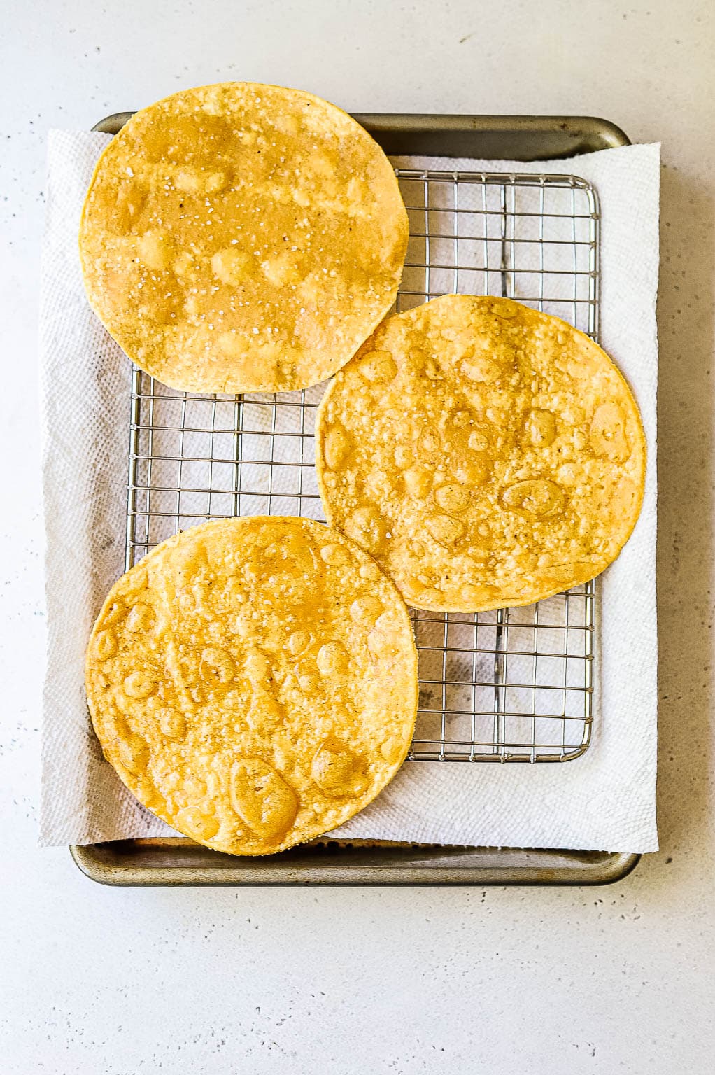 Crispy corn tortillas on a wire rack