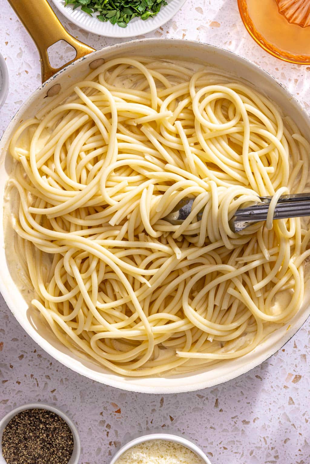 Pasta being tossed with the creamy lemon sauce