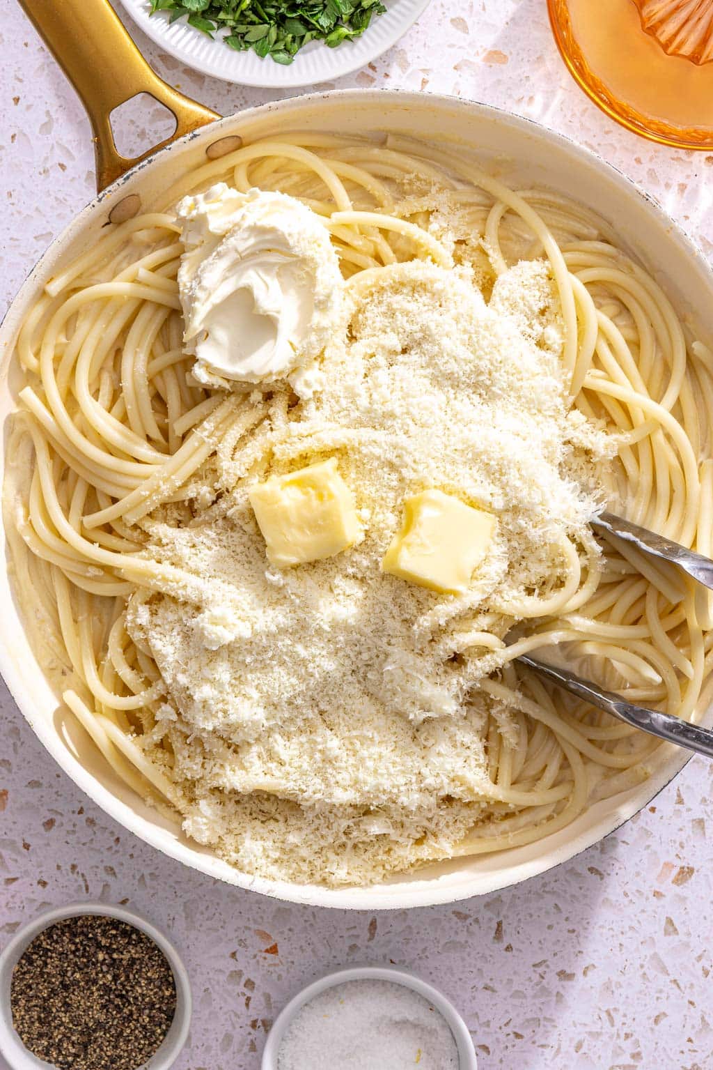 Mascarpone, butter, and pecorino being added to the pasta