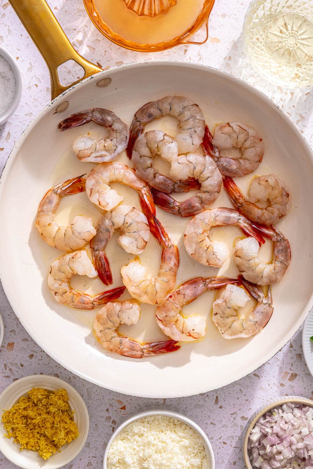 Shrimp in a single layer in a skillet