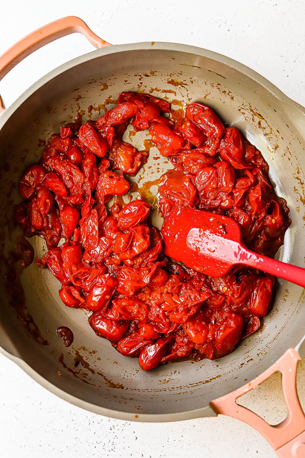 A paste of cooked tomatoes and Calabrian chiles in a skillet 