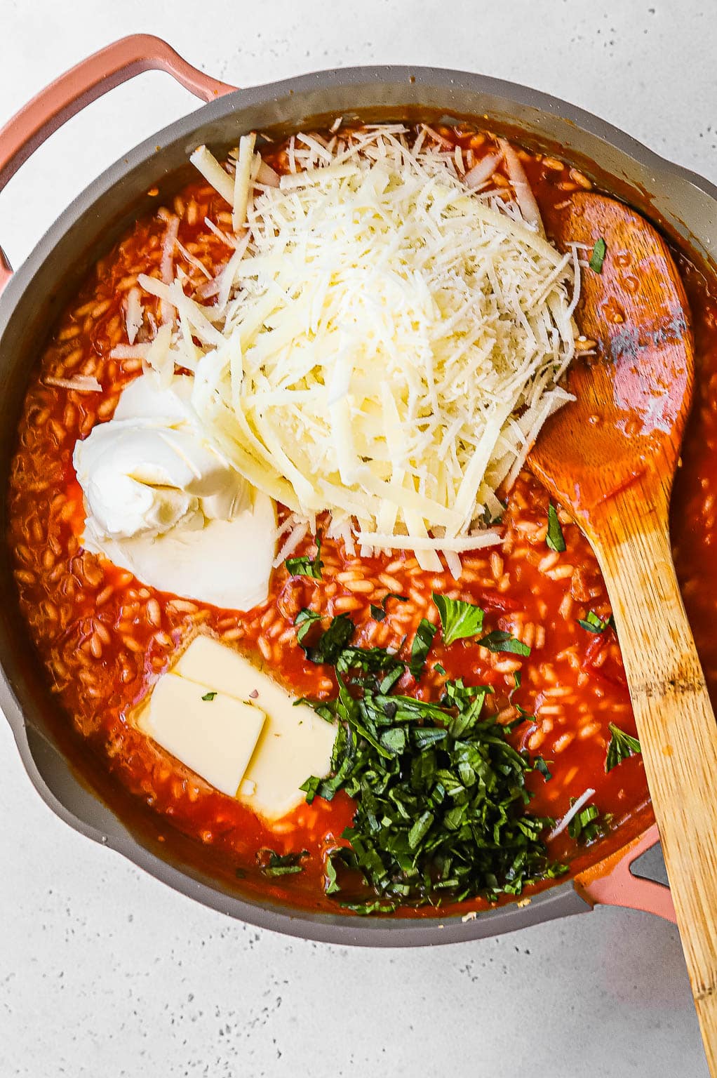 Fresh basil, mascarpone, and cheese mixed into tomato risotto 