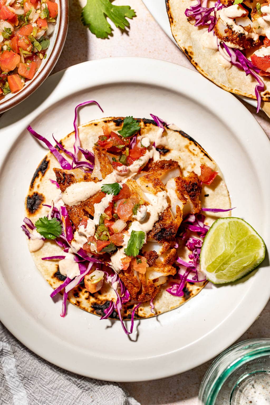 An assembled blackened fish taco on a plate