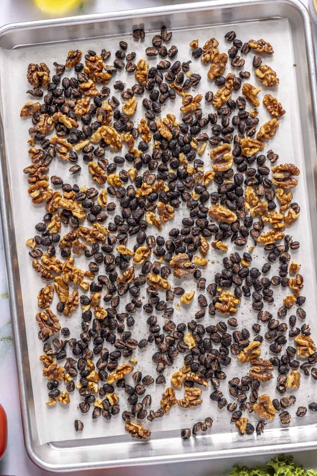 walnuts and beans laid out on a baking sheet