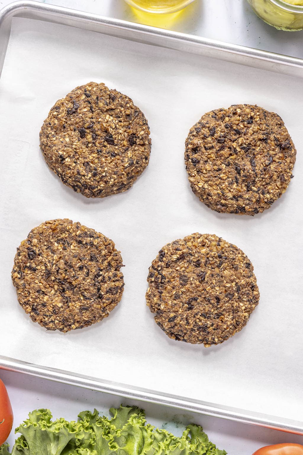 shaped black bean burgers on a baking sheet