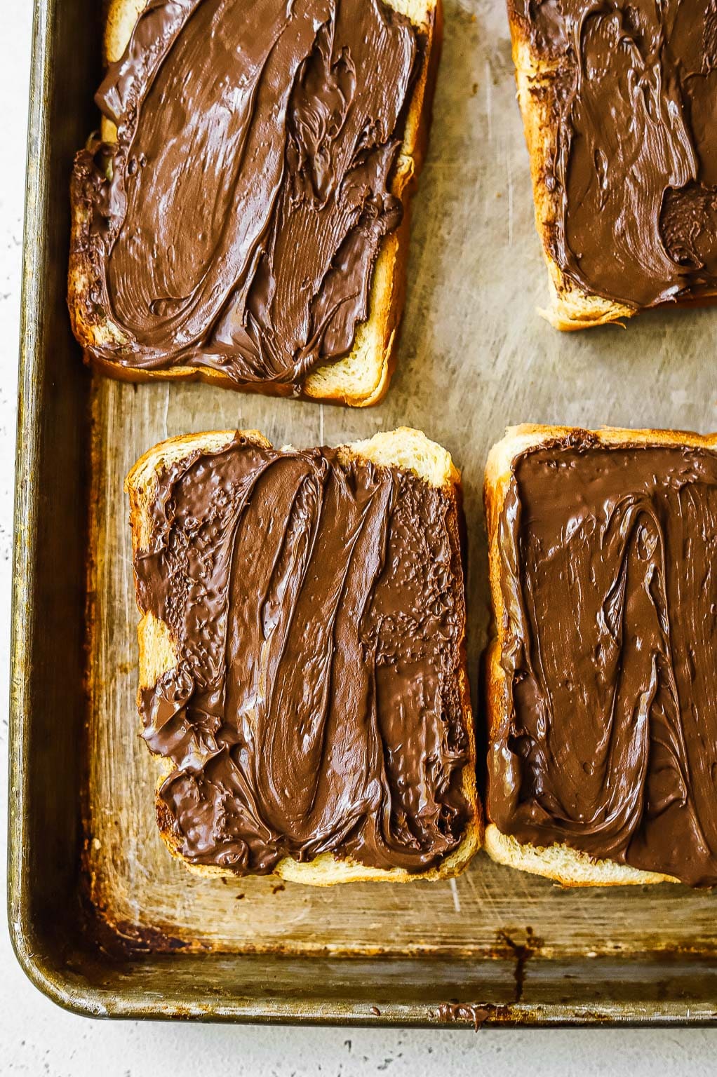 Slices of brioche bread slathered with Nutella 