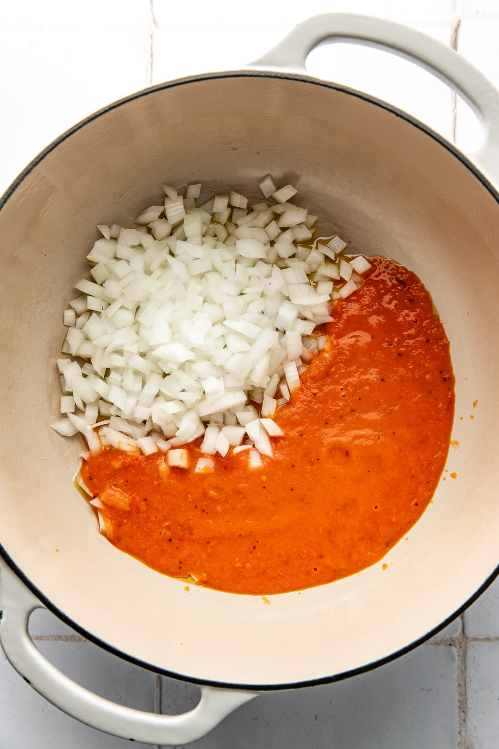 tomato sauce and onions in a pot