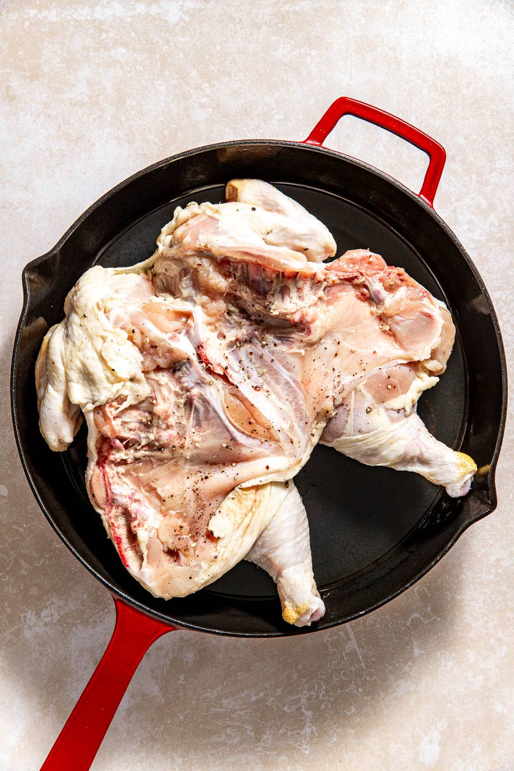 Chicken skin-side down in a cast iron skillet