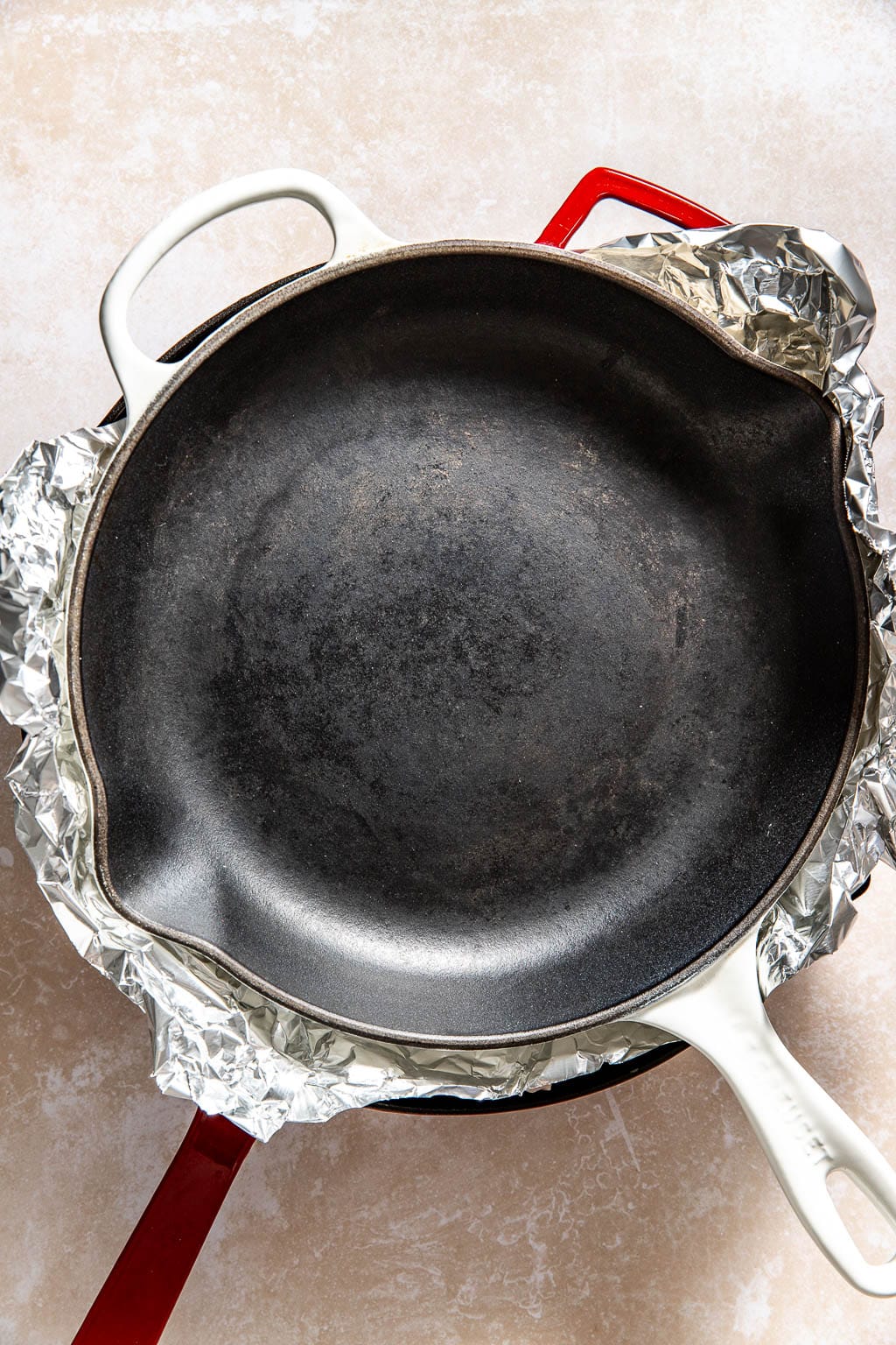 Chicken being weighed down with another pan