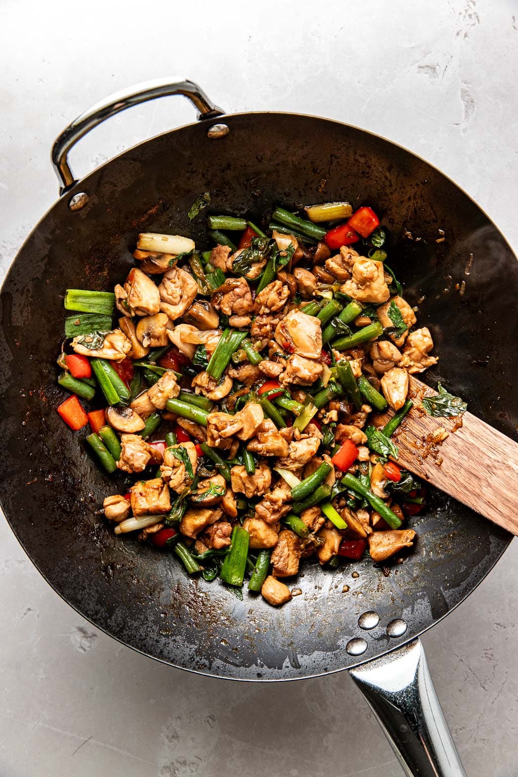 spicy Thai basil chicken in a wok 