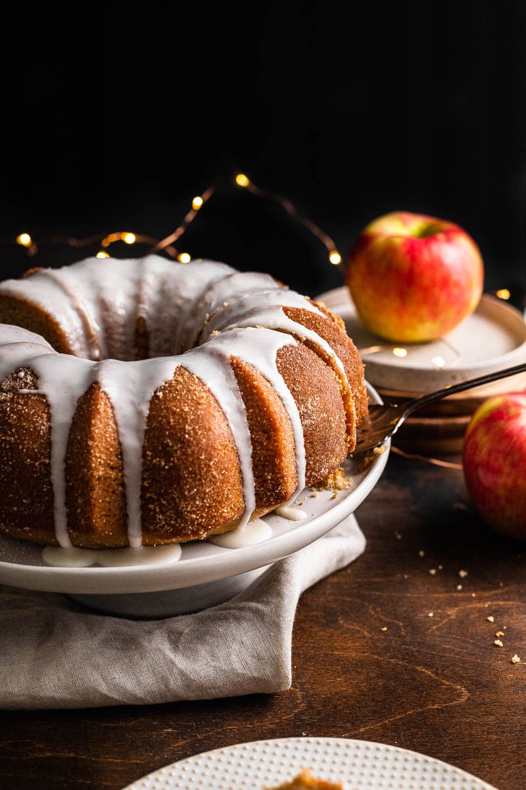 An apple Cider Donut bundt Cake on a cake stand 