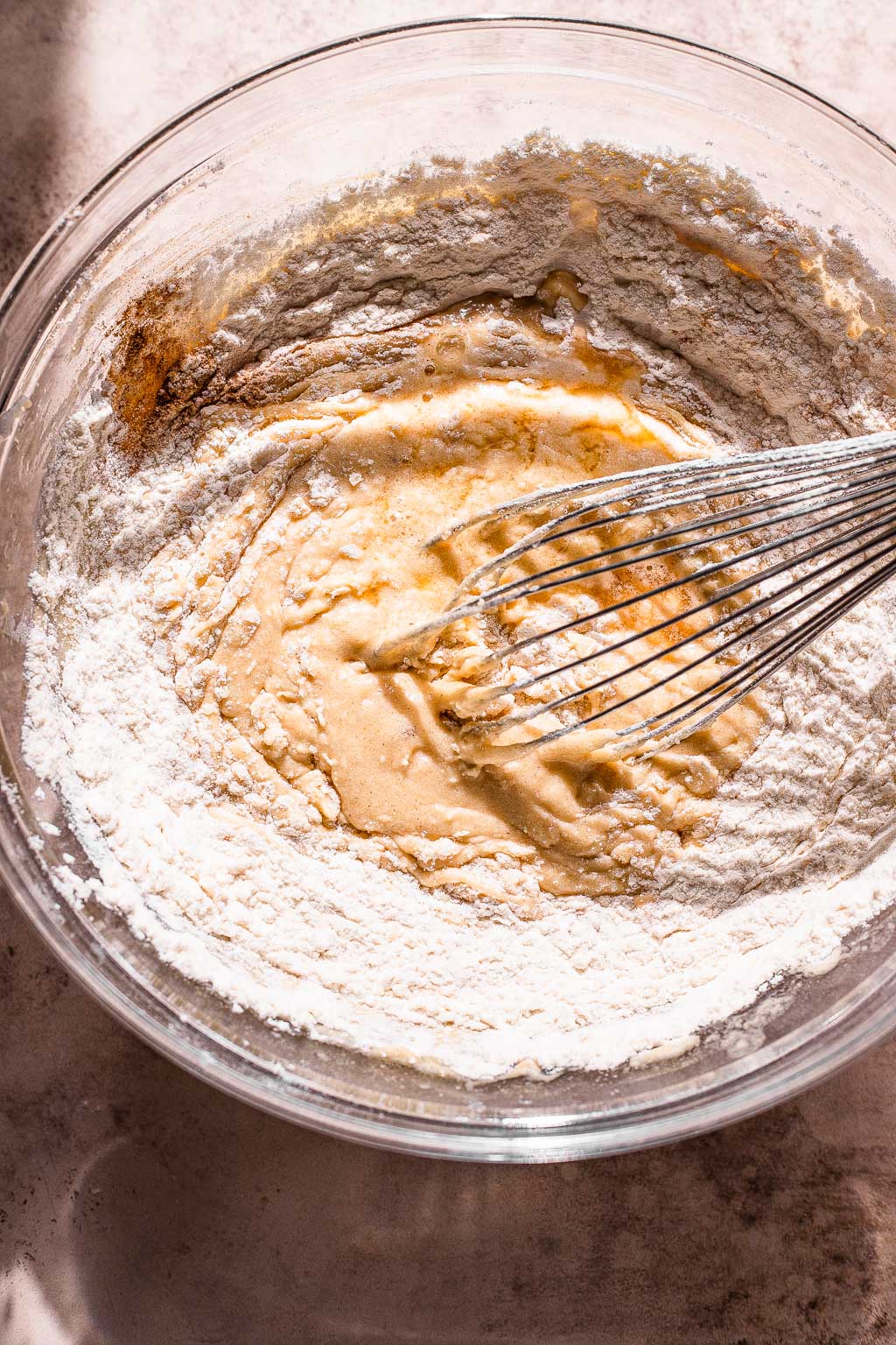 Apple cider cake batter being whisked together 