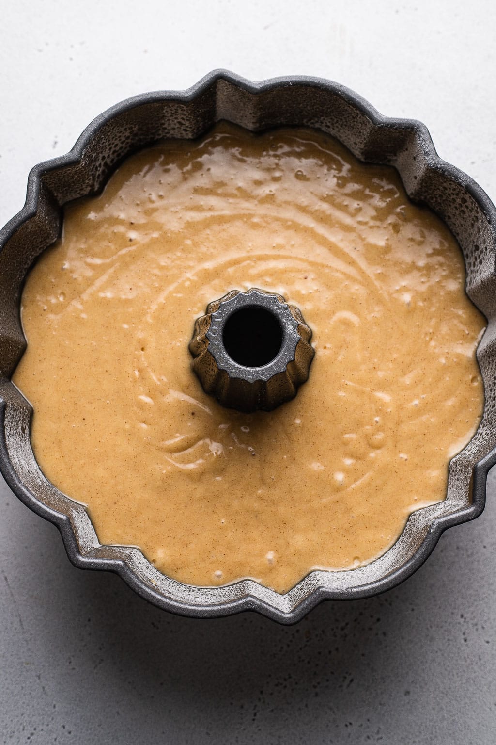 Raw cake batter in a bundt pan