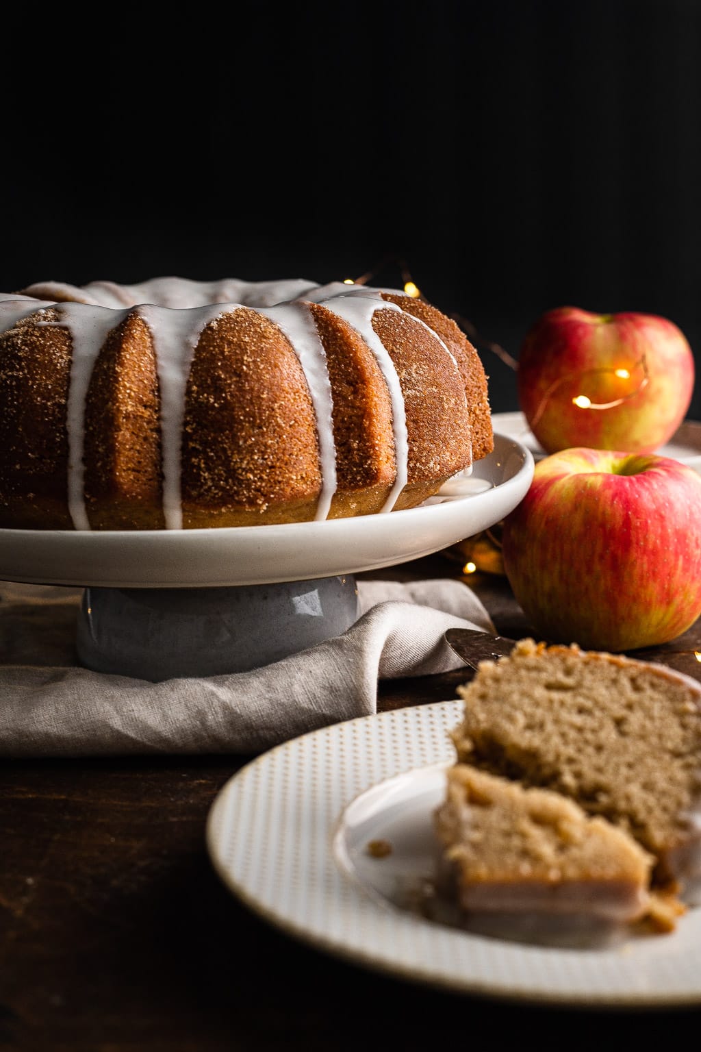 Apple Cider Donut cake, with one slice on a plate in front 