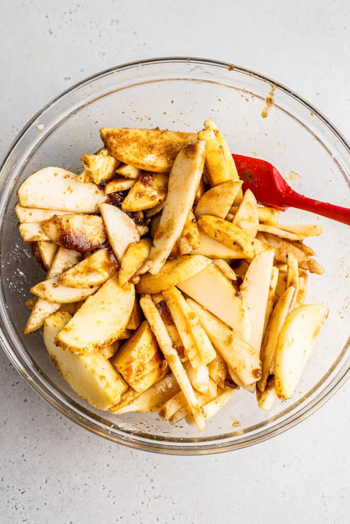 spiced apples and pears in a mixing bowl 
