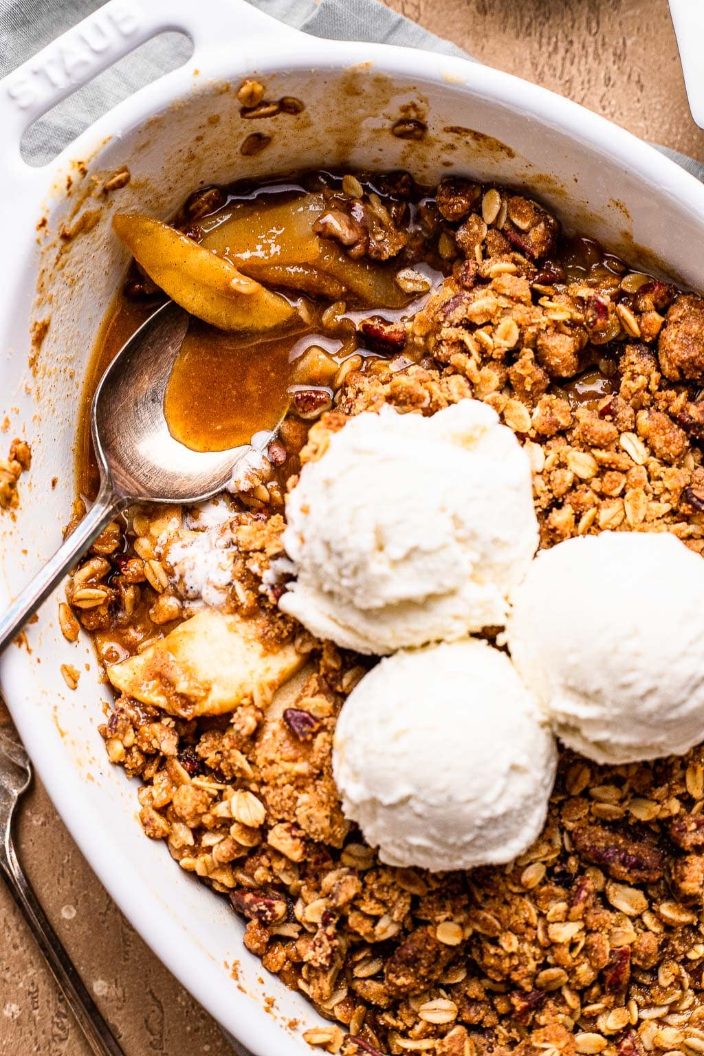 Apple Pear Crisp topped with scoops of vanilla ice cream 