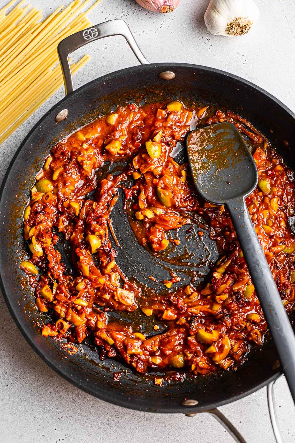 Tomato paste and caramelized shallots in a skillet