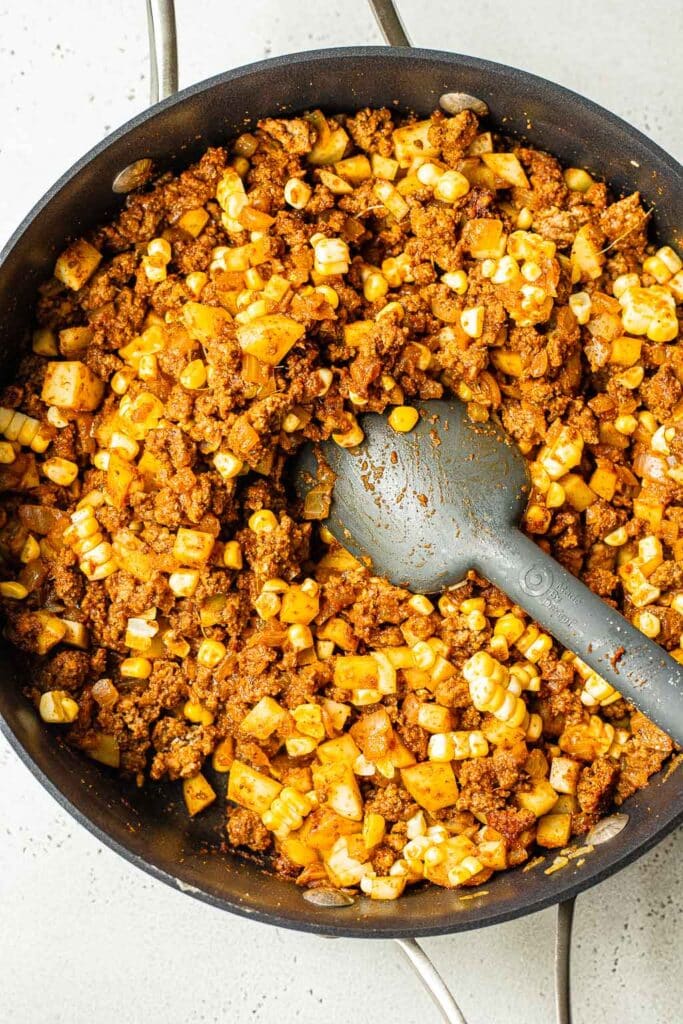 Ground beef enchilada filling in skillet 