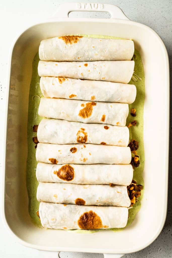 Rolled up enchiladas in baking dish 