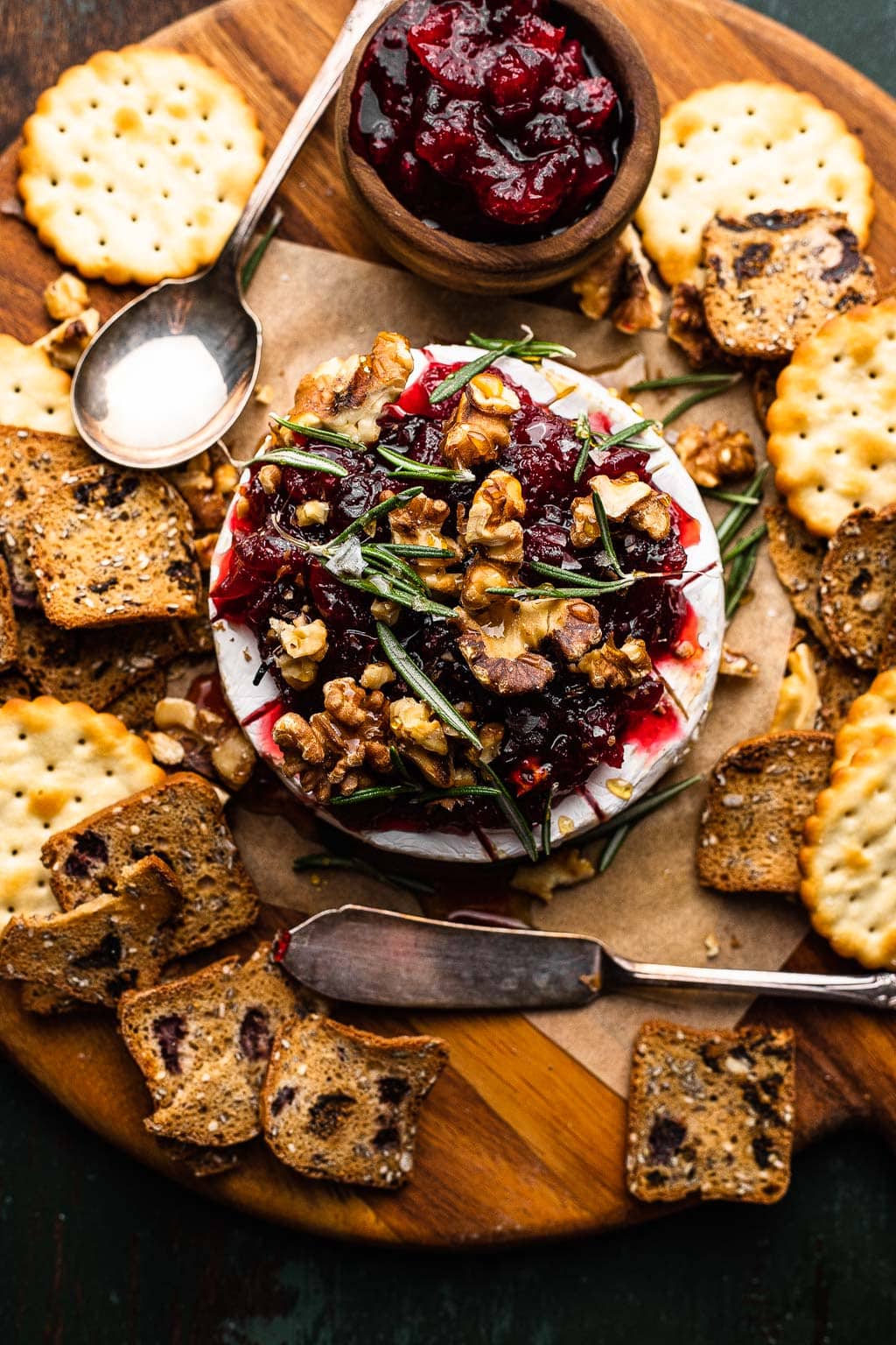 Baked brie topped with cranberry sauce and walnuts