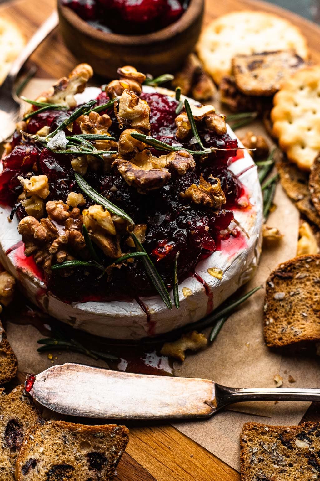 Baked brie topped with cranberry sauce and walnuts