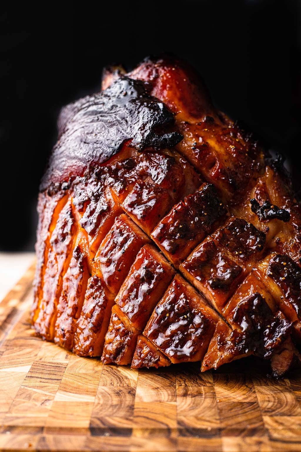 A ham cut side down on a cutting board 