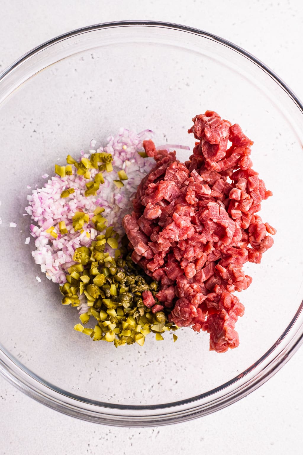 Ingredients for steak tartare in bowl 