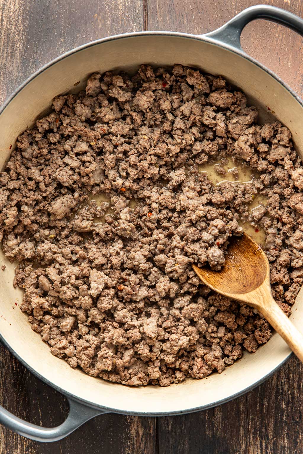 Cooked Italian sausage and ground beef in a Dutch oven 