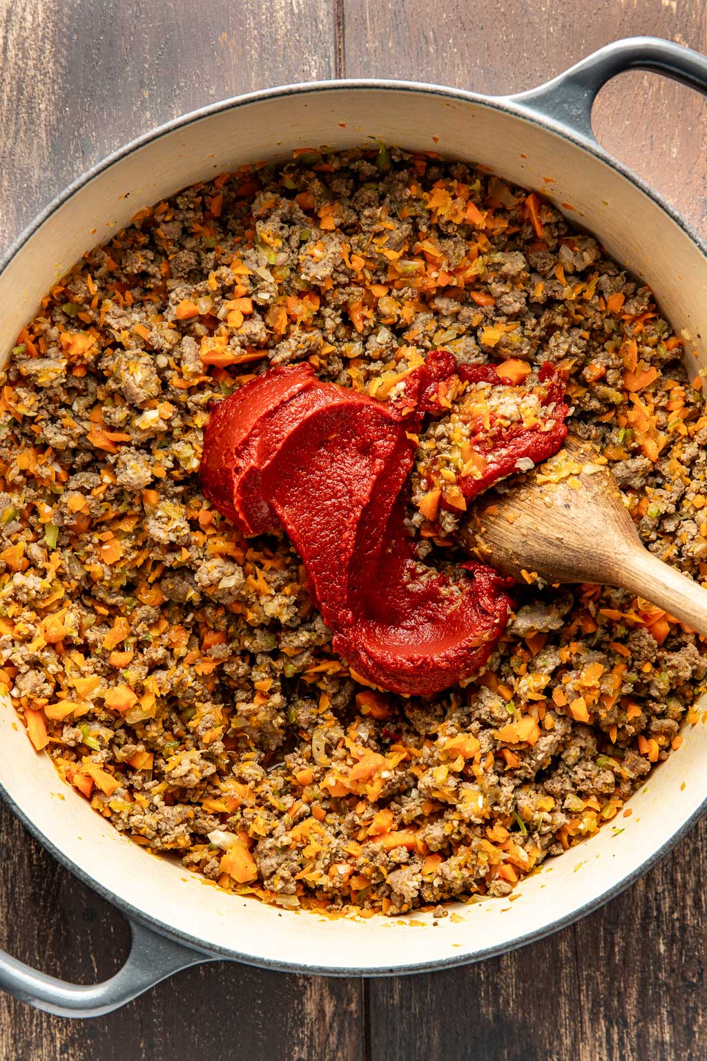 Soffritto and ground beef and Italian sausage in a Dutch oven 