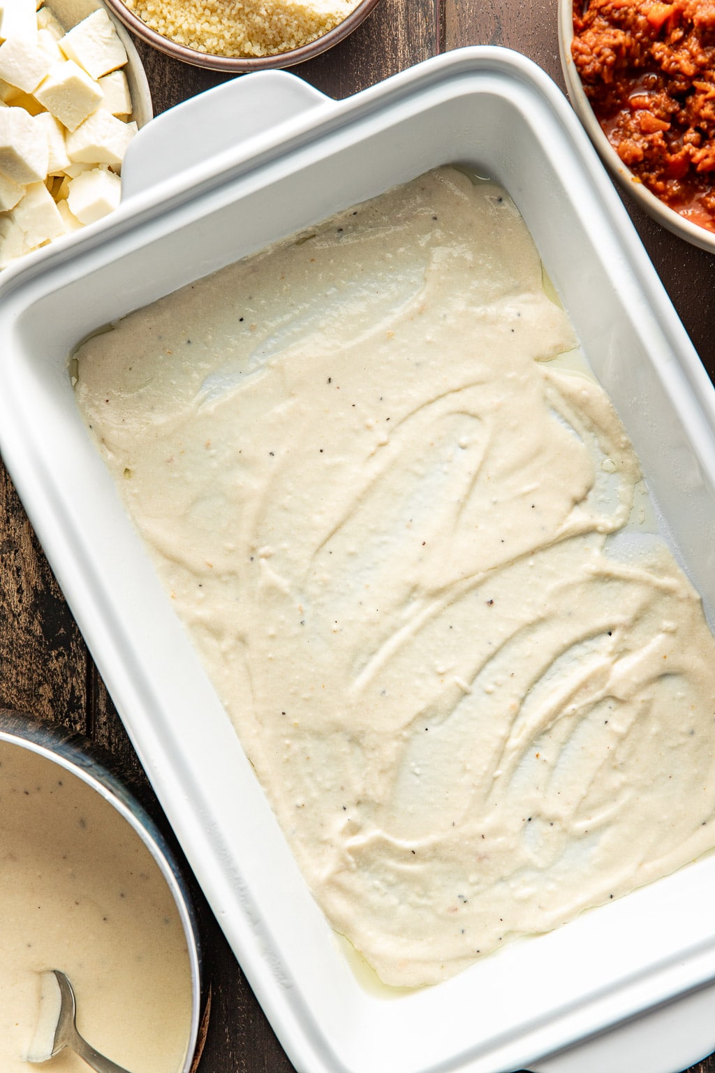 Béchamel sauce in the bottom of a baking dish. 