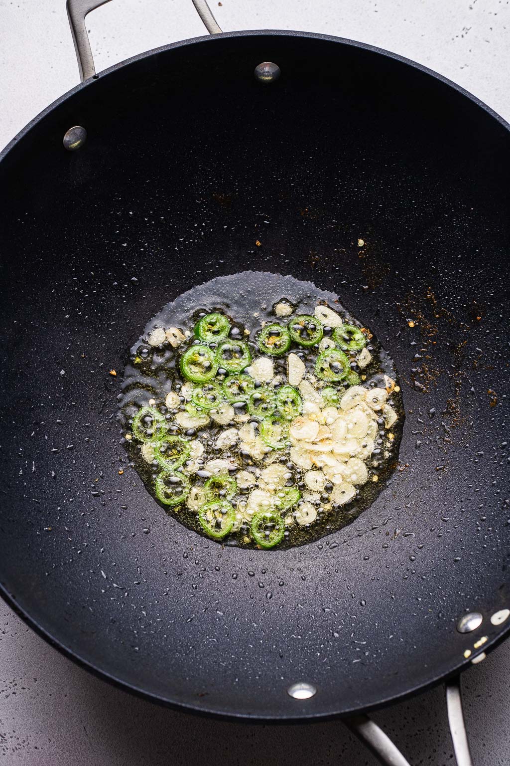 Garlic and peppers cooking in a wok