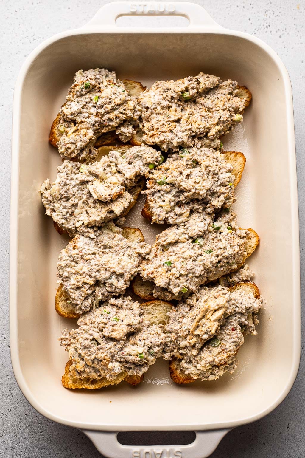 Sausage filling spread over croissants 