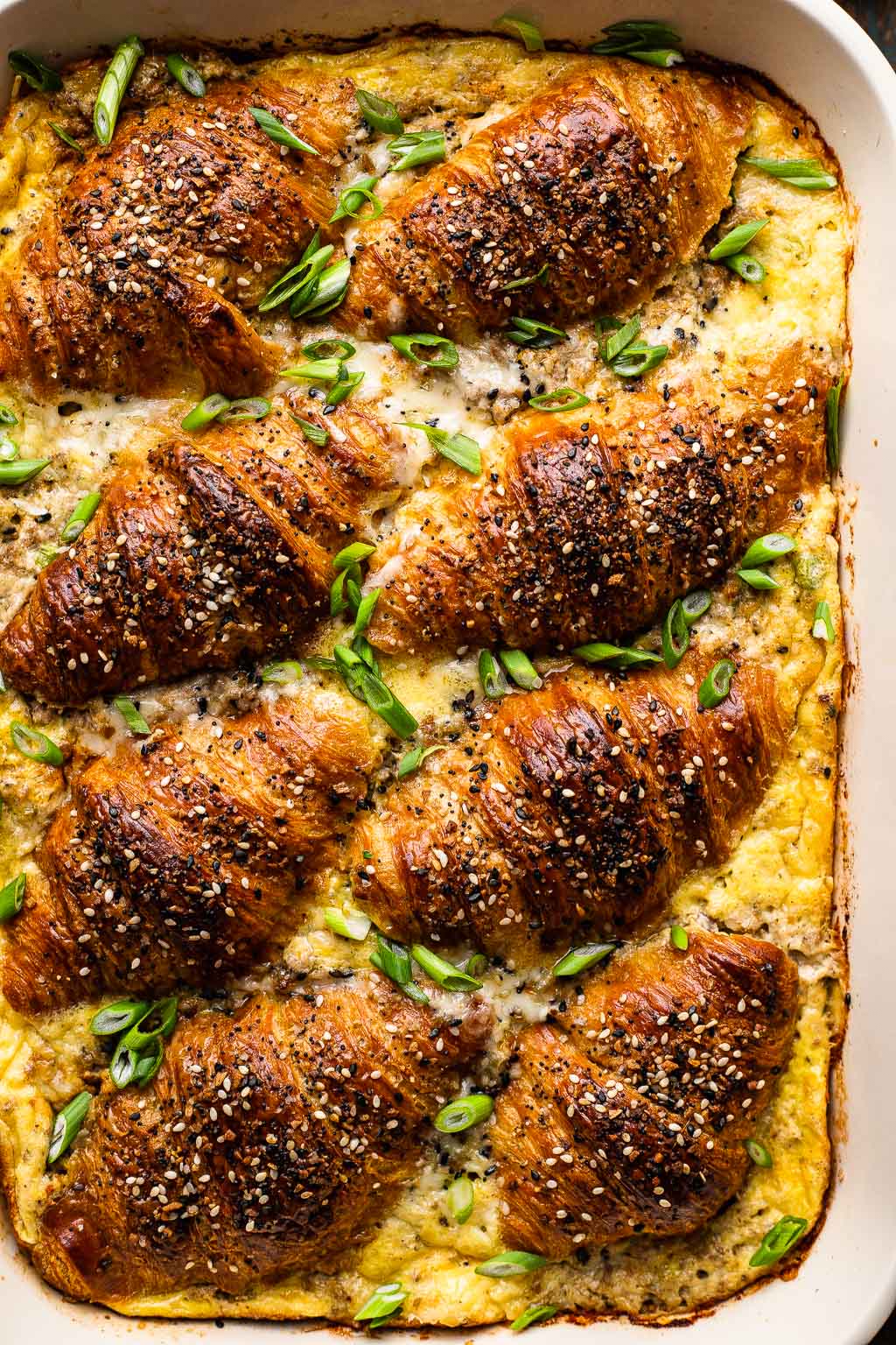Croissant Breakfast Casserole topped with green onion 