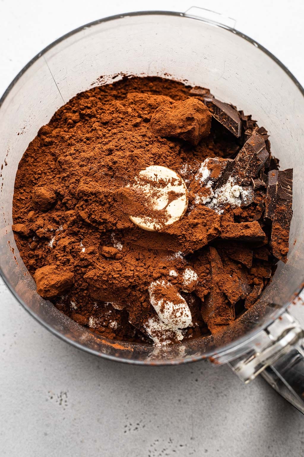 Cocoa powder and powdered milk in a food processor. 