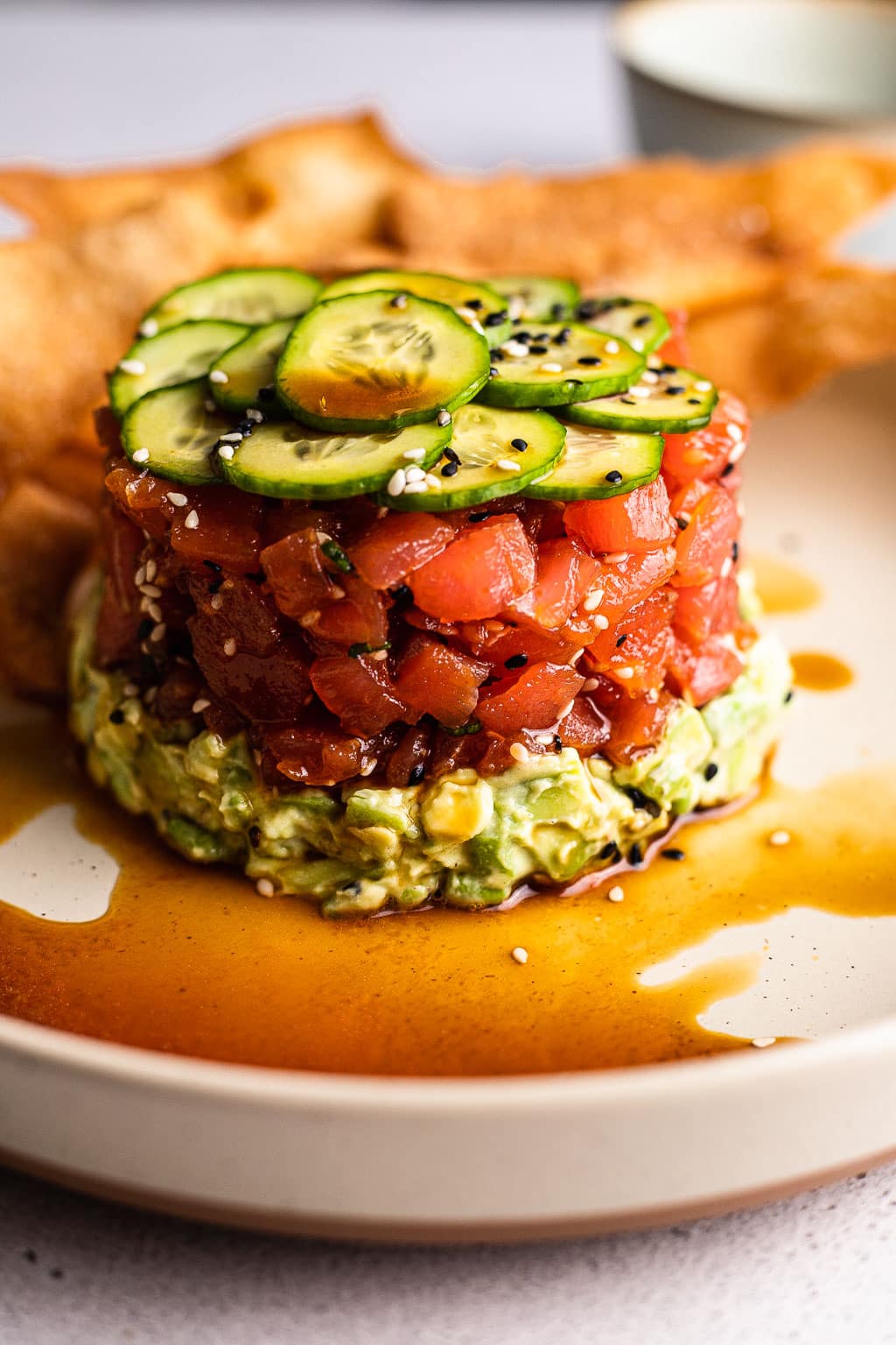 avocado tuna tartare with wonton chips on a plate 