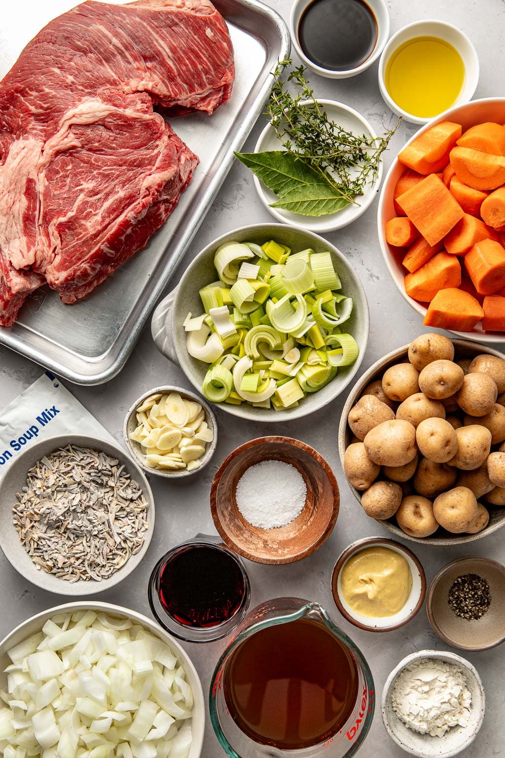 pot roast ingredients laid out on a grey background