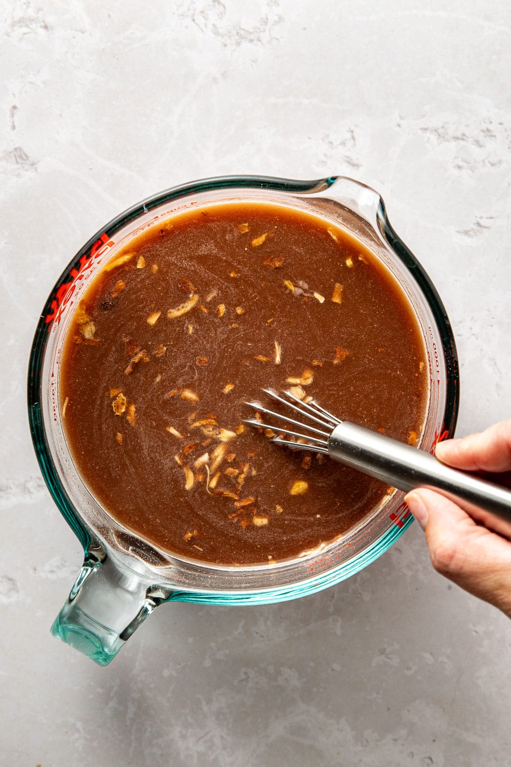 pot roast braising liquid in a glass measuring cup