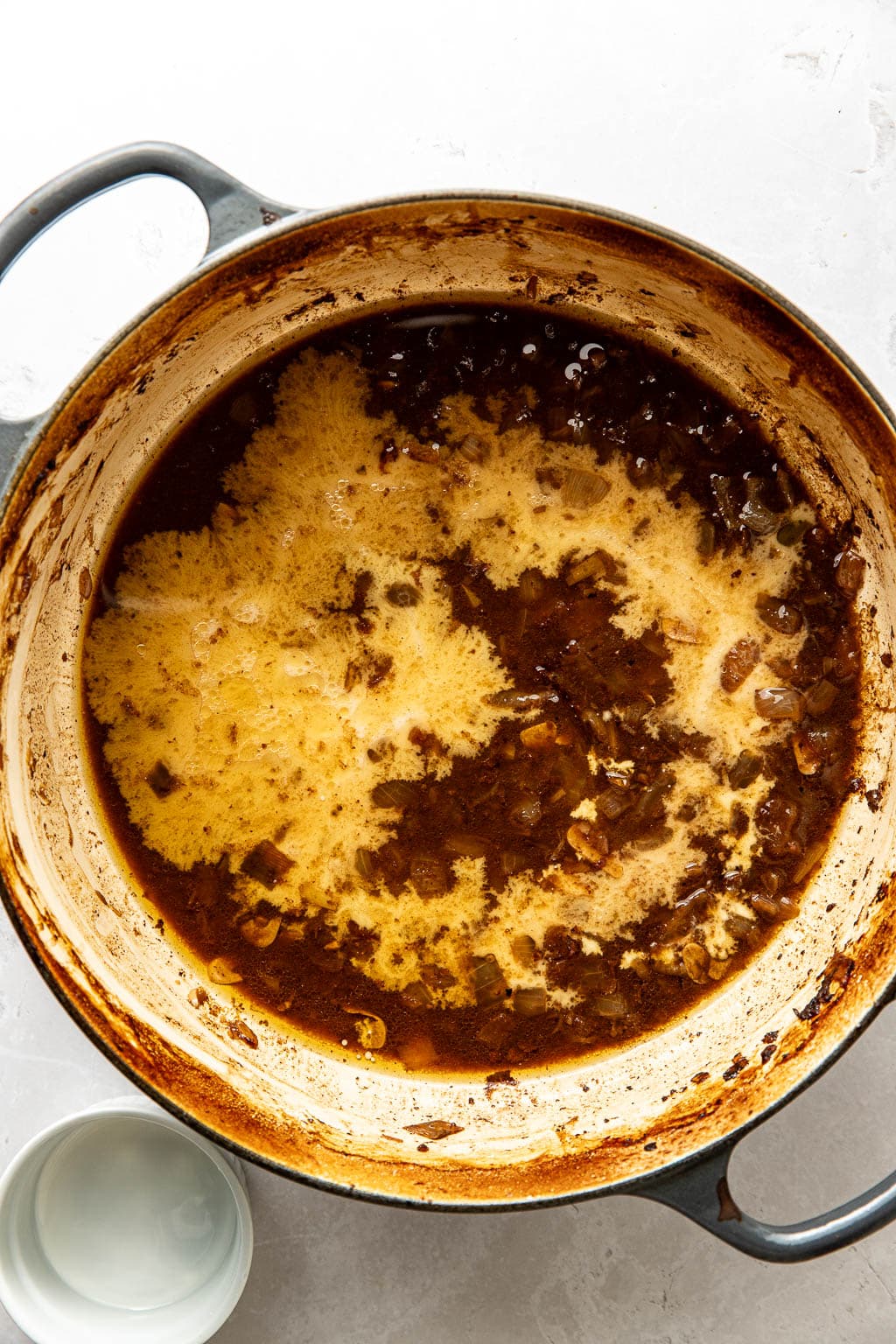 corn starch slurry being added to pot roast liquid