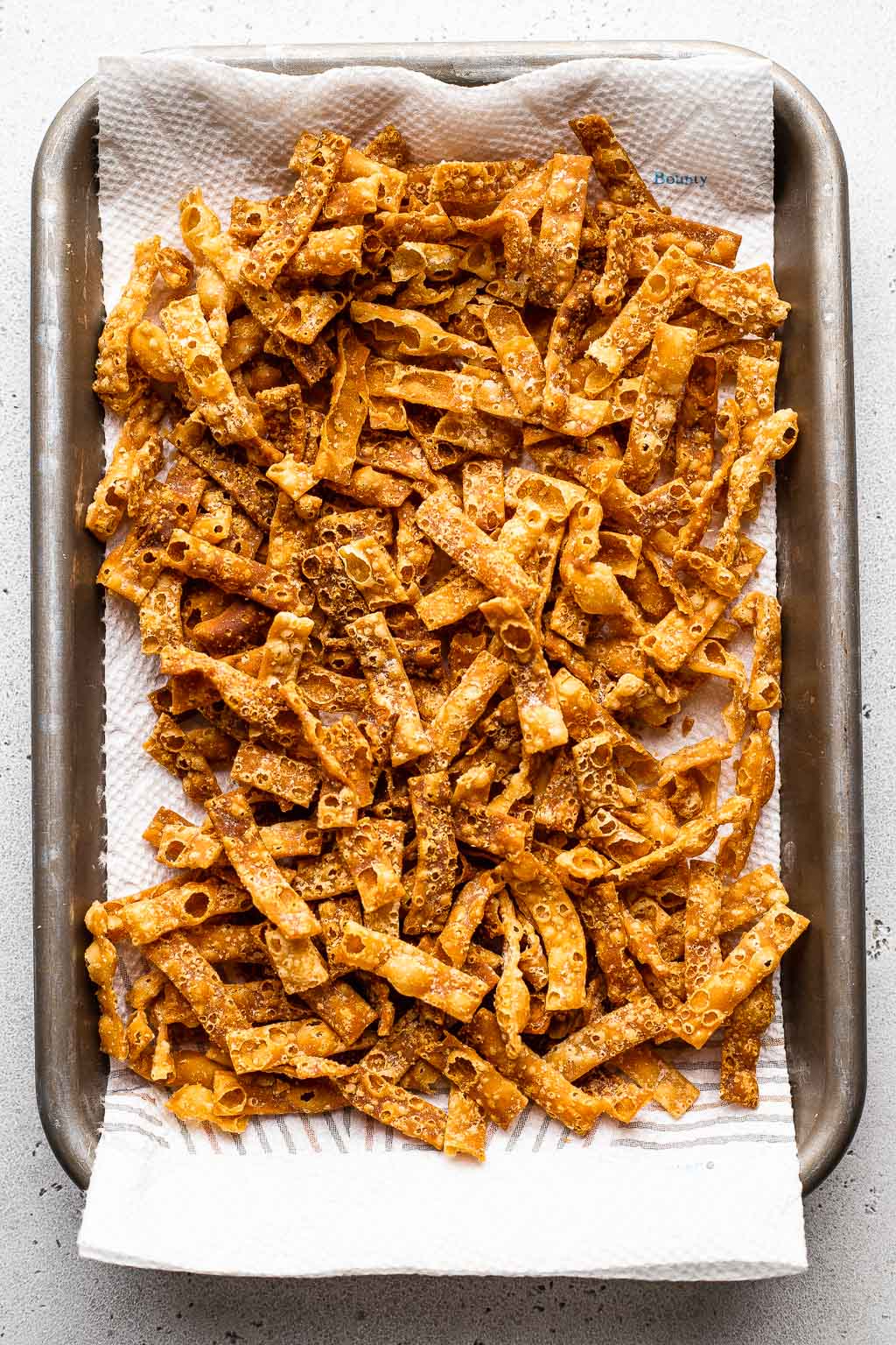 Crispy wonton strips on baking tray