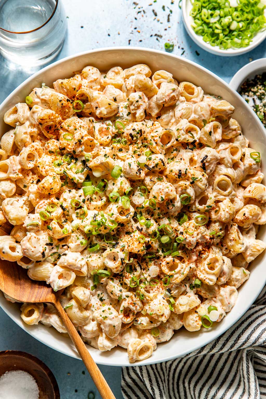 finished mac salad in a large serving bowl with a wooden spoon