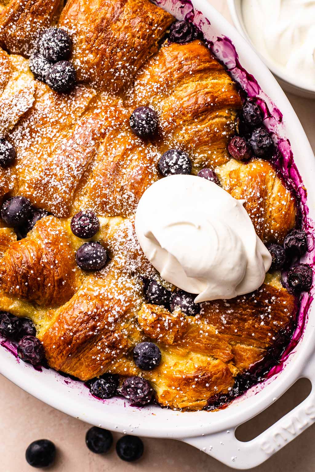 blueberry breakfast casserole topped with cream 