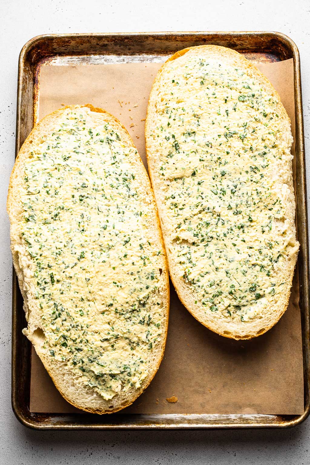 a loaf of french bread spread with garlic butter 