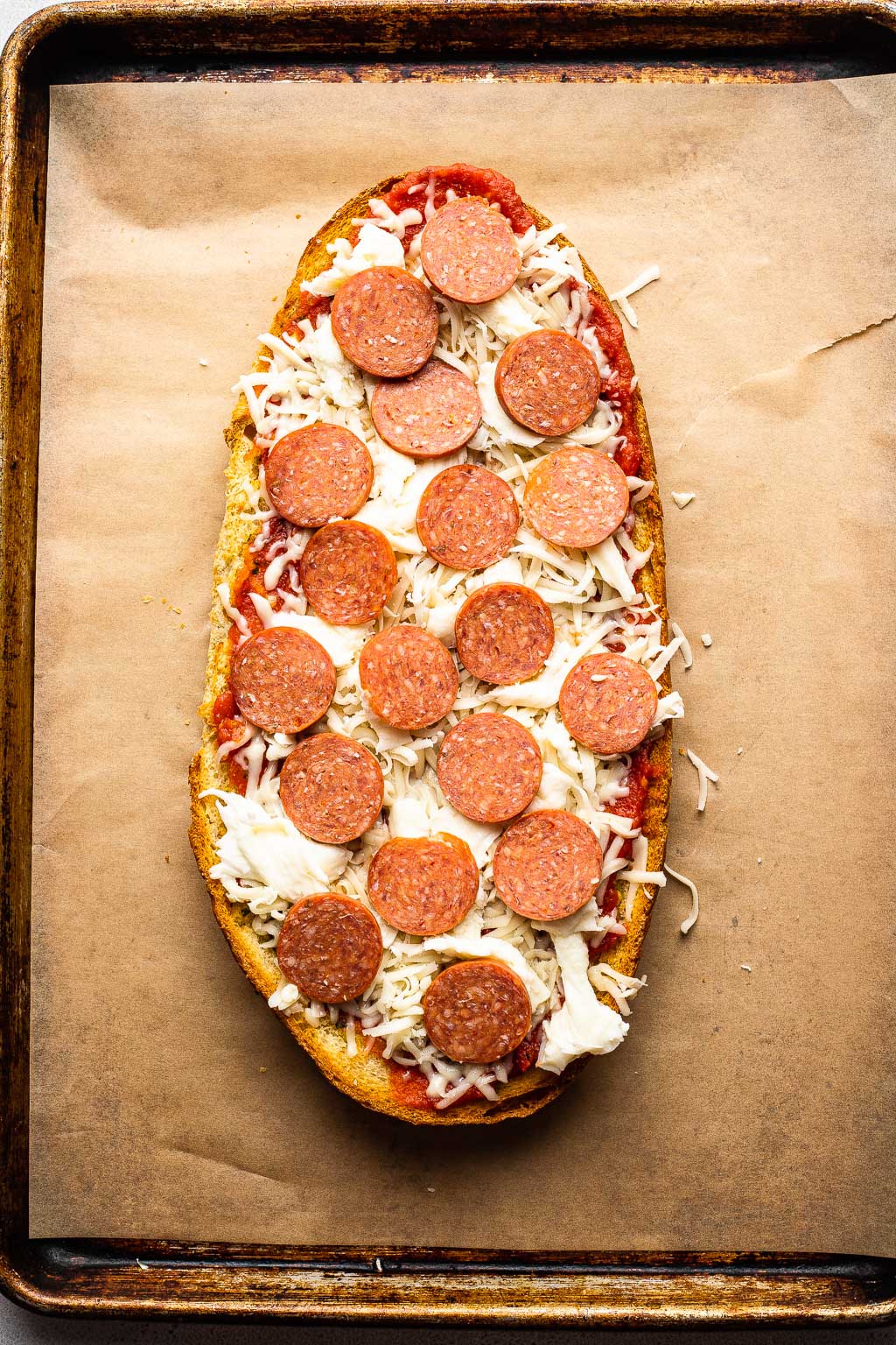 a french bread pizza ready to be baked