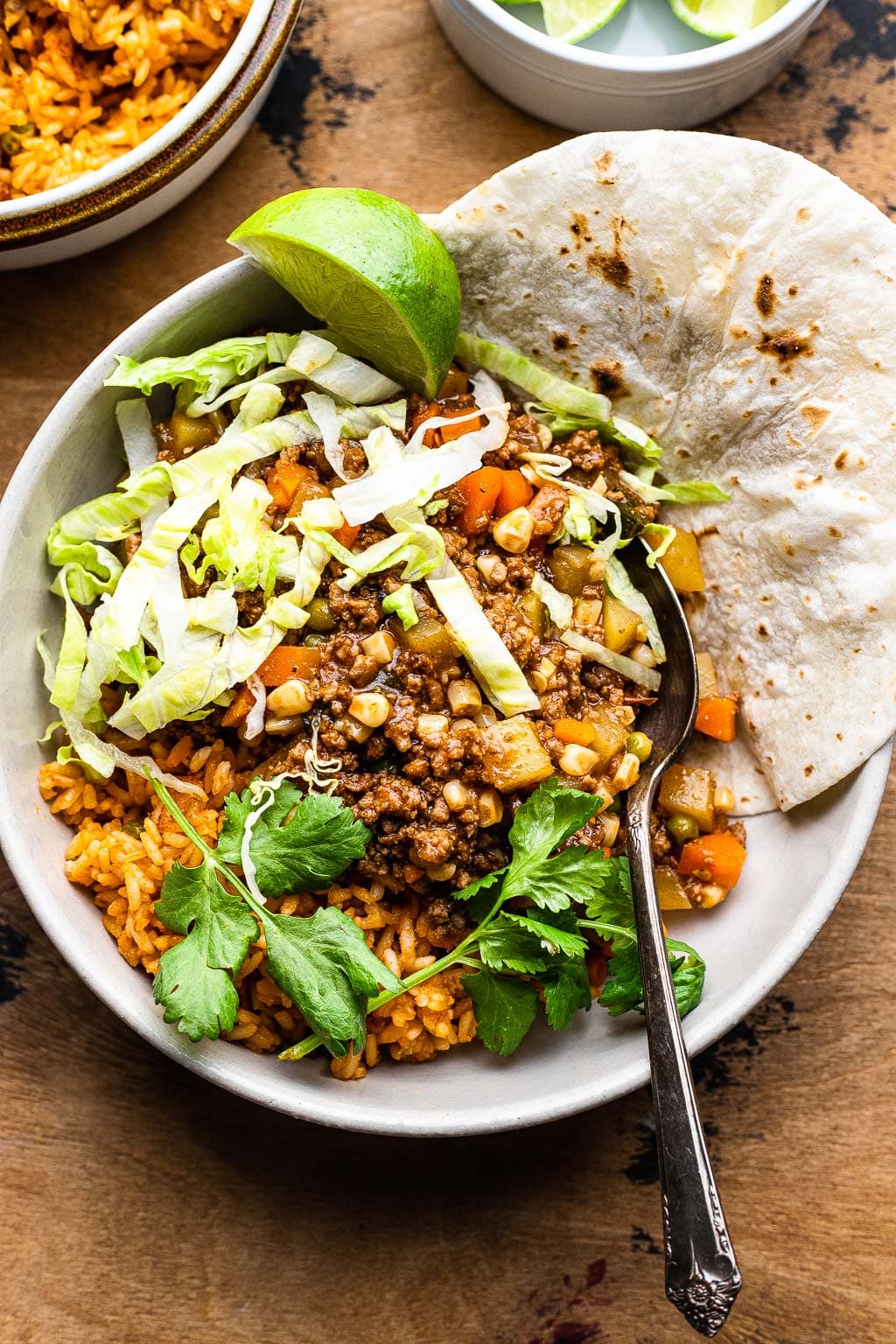 Mexican Picadillo with lettuce, lime, and tortilla 