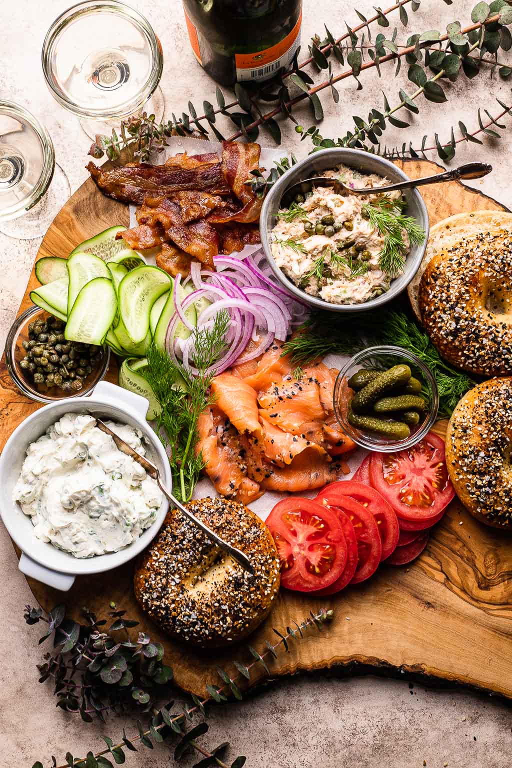 A bagel board with smoked salmon and various toppings